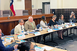 Secretary Scott sitting at a table with other stakeholders.