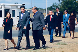 Secretary Hughs walking alongside with Mayor Pete Saenz and others.