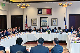 Texas Secretary of State Rolando Pablos sitting in a room with other committee members.