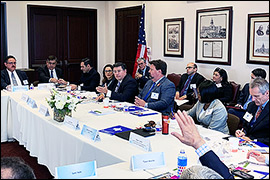 Texas Secretary of State Rolando Pablos sitting in a room with other committee members.