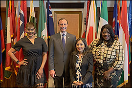 Secretary Whitley standing with U.S. Census representatives. 