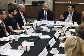 Secretary Pablos sitting at a table with other participants.