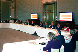 Photo of consular officials seated at a table.