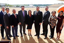 Secretary Hughs standing next to Laredo mayor Pete Saenz and other officials. 