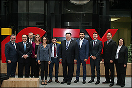Texas Secretary of State Rolando Pablos standing with the delegation in front of  a building.
