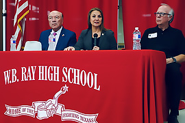 Secretary Hughs sitting at a table with Senator Hinojosa and Representative Hunter